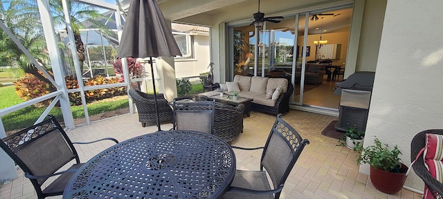 sunroom with ceiling fan with notable chandelier