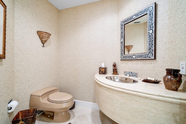 bathroom with tile patterned flooring, sink, and toilet