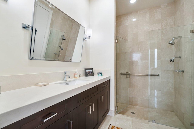 bathroom with vanity and a shower with shower door