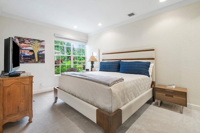 bedroom with ornamental molding and carpet floors