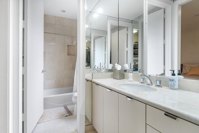 full bathroom with shower / tub combo with curtain, tile patterned floors, toilet, and vanity