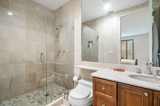 bathroom featuring vanity, an enclosed shower, and toilet