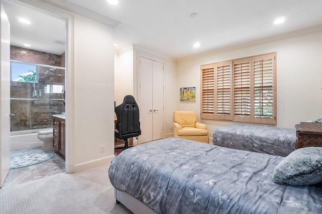 bedroom with crown molding, connected bathroom, and a closet