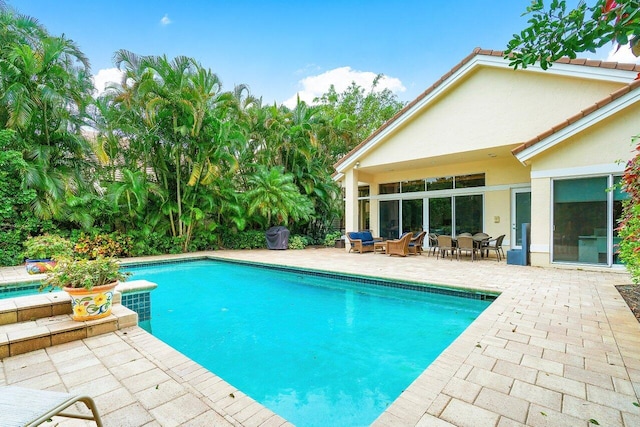 view of swimming pool featuring an outdoor living space and a patio area