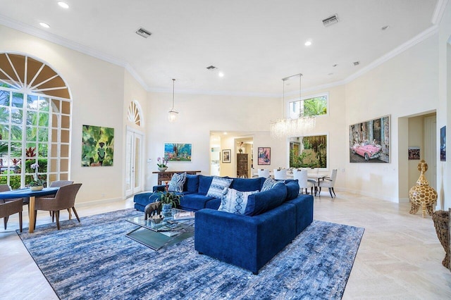 living room with a high ceiling, ornamental molding, and an inviting chandelier