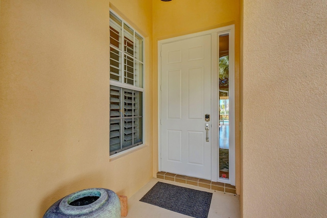 property entrance with stucco siding