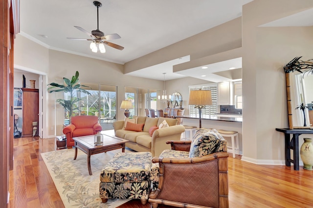 living room featuring crown molding, ceiling fan, and light hardwood / wood-style flooring