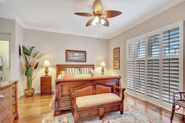 bedroom with ornamental molding, ceiling fan, baseboards, and wood finished floors