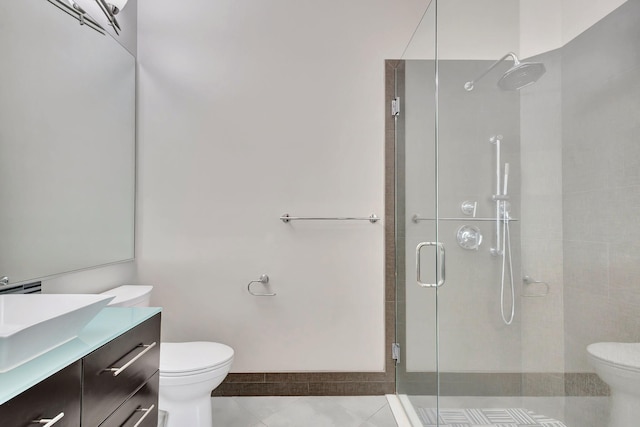 bathroom featuring vanity, an enclosed shower, tile patterned floors, and toilet