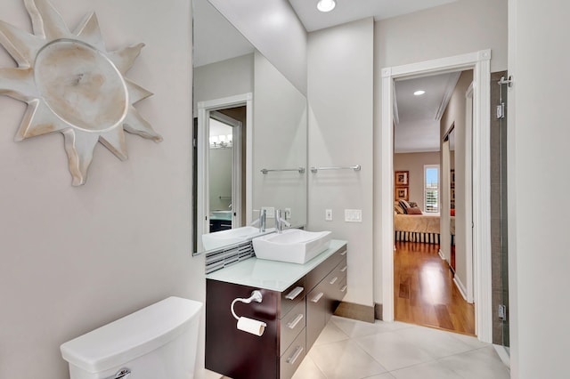 bathroom with connected bathroom, toilet, recessed lighting, vanity, and tile patterned floors