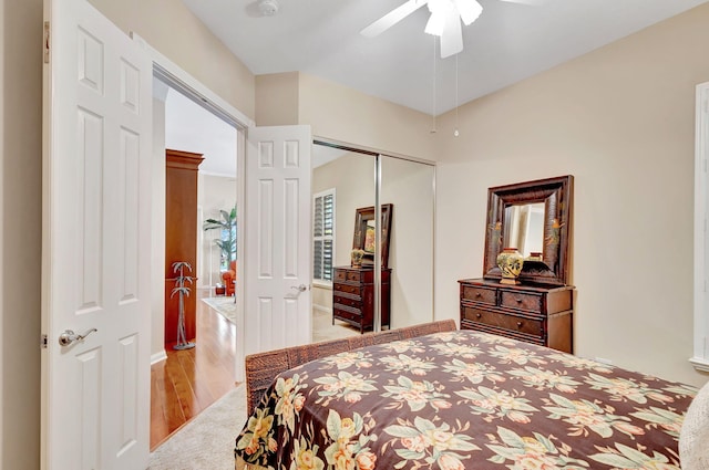 bedroom with ceiling fan, light wood-type flooring, and a closet