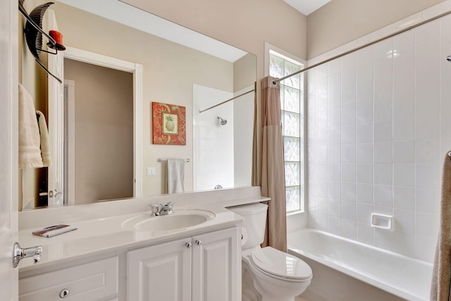 full bathroom featuring vanity, toilet, and tiled shower / bath combo