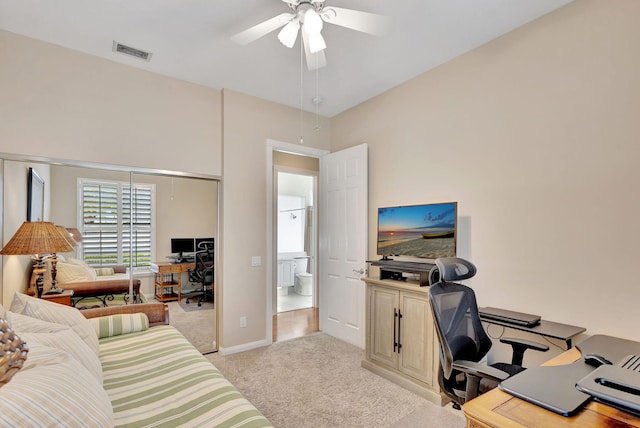 home office featuring light carpet, baseboards, visible vents, and a ceiling fan