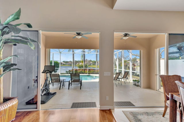 interior space featuring a ceiling fan, glass enclosure, and an outdoor pool