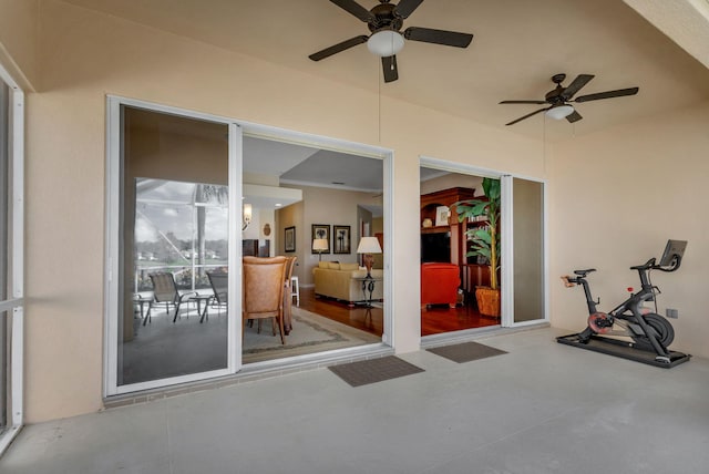 workout room featuring a sunroom and ceiling fan