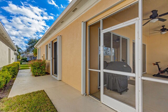 exterior space featuring a patio area, a sunroom, and ceiling fan