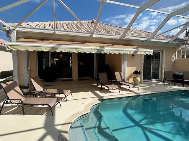 rear view of property featuring a lanai and a patio