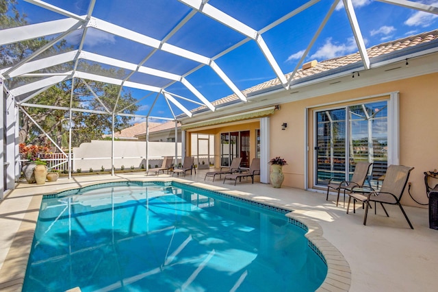 view of swimming pool with a patio and glass enclosure