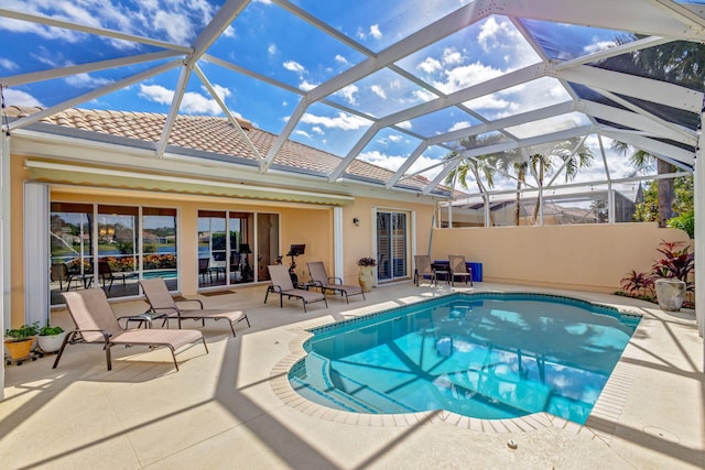 view of swimming pool with a fenced in pool, a lanai, and a patio