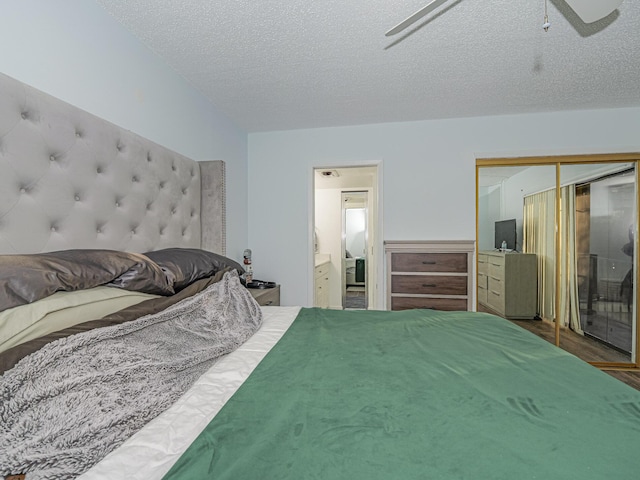 bedroom with a textured ceiling, ceiling fan, and a closet