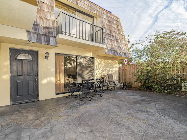 view of patio featuring a balcony