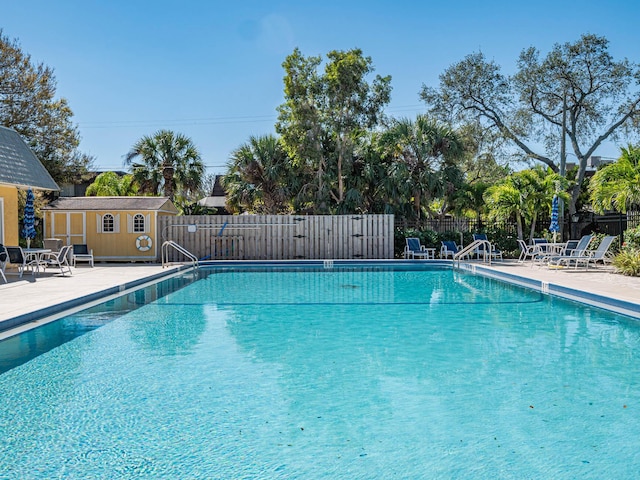 view of swimming pool with a patio area and an outdoor structure