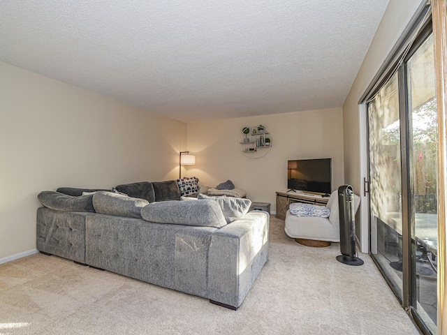 carpeted living room featuring a textured ceiling