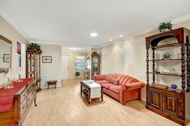 living area with baseboards, visible vents, light wood finished floors, ornamental molding, and a textured ceiling