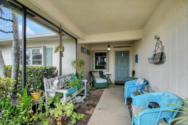 entrance to property featuring stucco siding and a porch