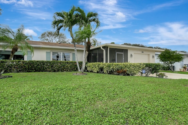 ranch-style home with concrete driveway, a front yard, stucco siding, a sunroom, and an attached garage