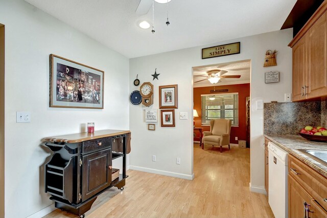 kitchen featuring white appliances, plenty of natural light, sink, and light wood-type flooring