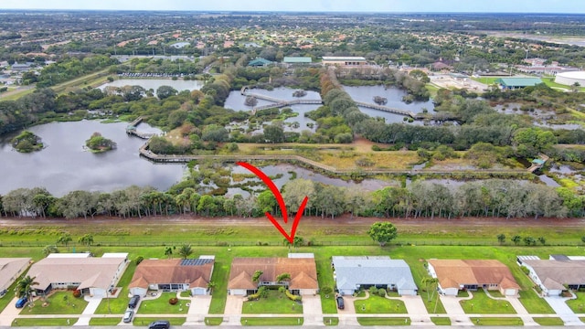 drone / aerial view featuring a residential view and a water view