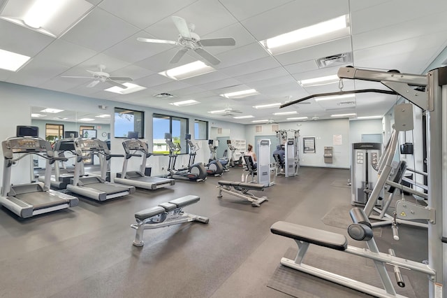 workout area featuring visible vents, ceiling fan, and a drop ceiling