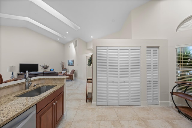 kitchen featuring light tile patterned flooring, sink, high vaulted ceiling, dishwasher, and light stone countertops