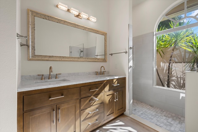 bathroom with vanity and tiled shower