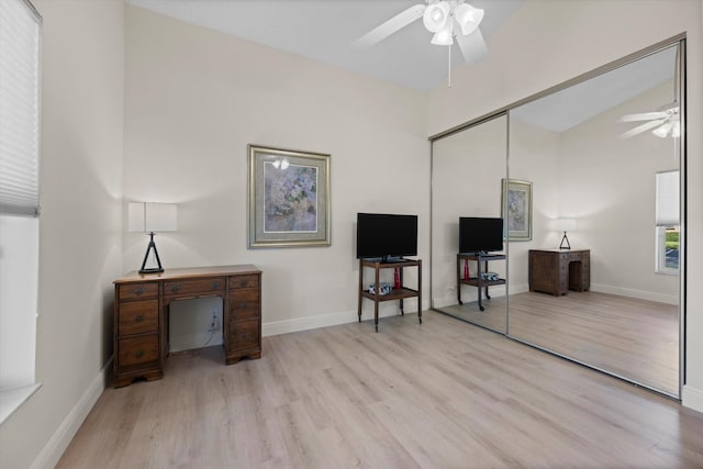 interior space with lofted ceiling, ceiling fan, and light hardwood / wood-style flooring