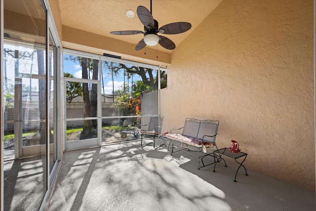 unfurnished sunroom featuring vaulted ceiling and ceiling fan