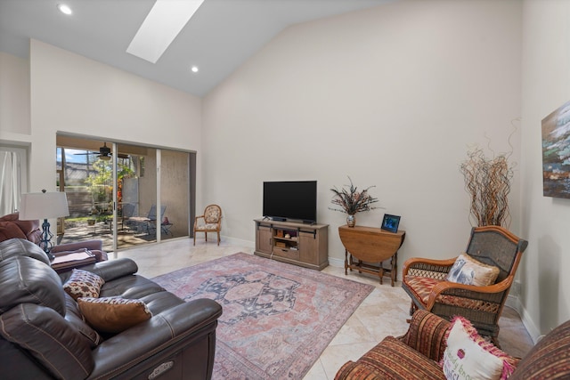 living room with a skylight and high vaulted ceiling