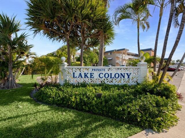 community / neighborhood sign with a lawn