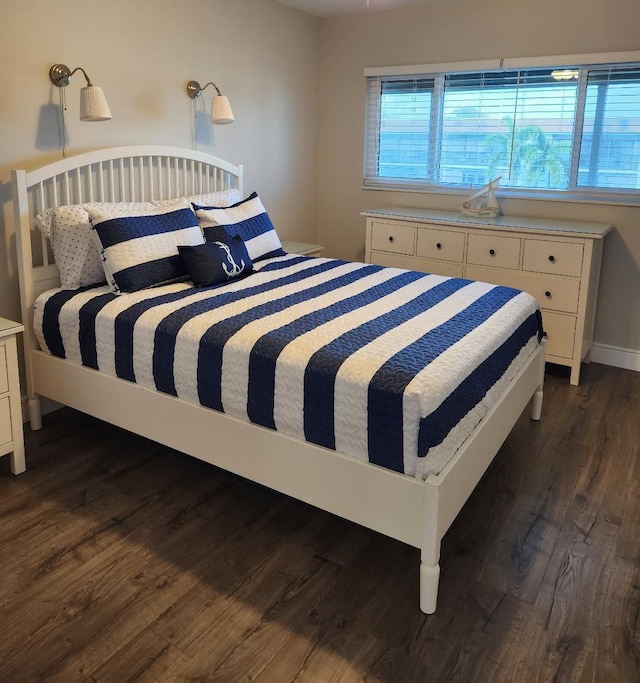 bedroom with dark hardwood / wood-style floors