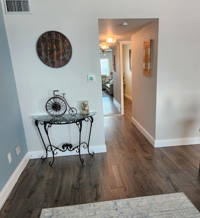 corridor with dark hardwood / wood-style flooring