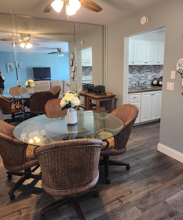 dining area featuring dark hardwood / wood-style flooring and sink