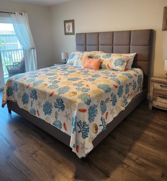 bedroom with dark wood-type flooring and access to outside