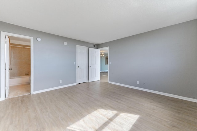 spare room with light hardwood / wood-style flooring