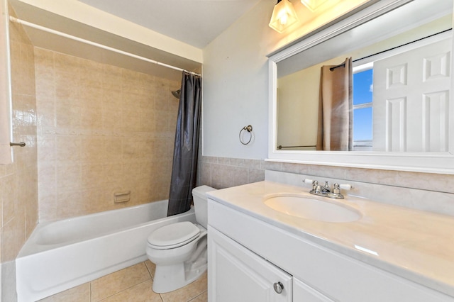 full bathroom featuring shower / tub combo with curtain, toilet, tile walls, vanity, and tile patterned flooring