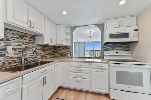 kitchen featuring tasteful backsplash, white cabinetry, sink, white appliances, and light hardwood / wood-style flooring