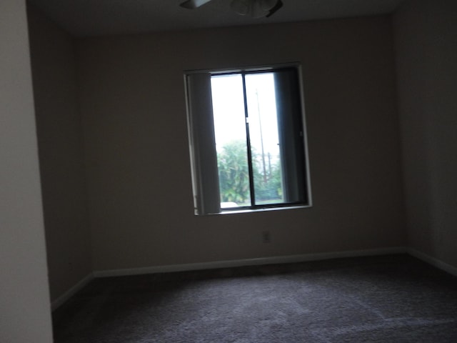 empty room featuring ceiling fan and carpet flooring