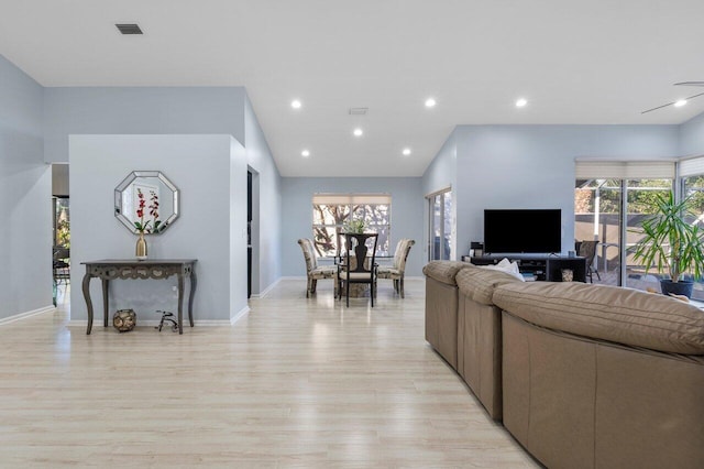 living room with plenty of natural light and light wood-type flooring