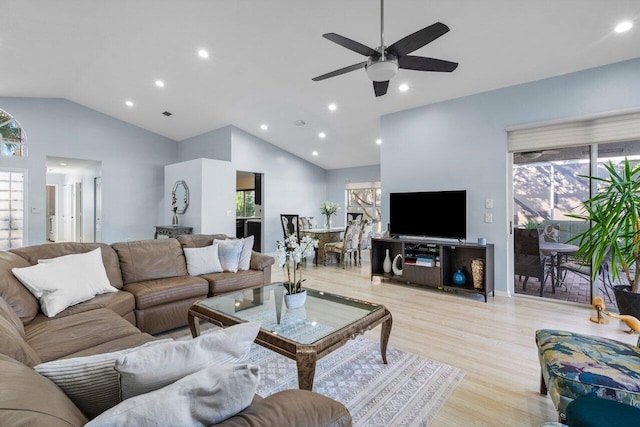 living room featuring ceiling fan, lofted ceiling, and light hardwood / wood-style floors