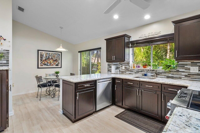 kitchen featuring stainless steel appliances, sink, backsplash, and decorative light fixtures